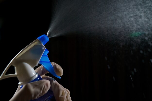 woman-with-blue-foggy-spraying-disinfectant_46370-1548